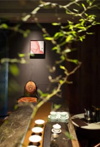 Dining area with a wooden table, chairs, and a vase, creating a cozy atmosphere for social gatherings