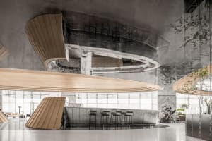 A modern bar with a curved counter, four stools, and a welcoming atmosphere