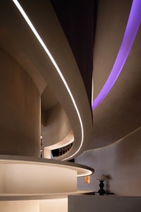 A rendered image of a spiral staircase in a tunnel-like space with curved walls and no visible materials or lighting