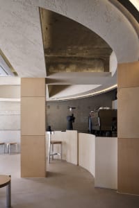 A clean and organized cafe counter with two chairs and three cups, designed for functionality and convenience