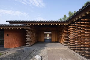 A large Asian-style building with wooden walls and a tiled roof, featuring a blend of modern and traditional interior design elements