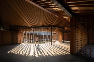 Warm and cozy indoor space with wooden floors and walls, featuring multiple chairs for socializing and relaxation