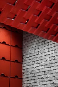 A traditional hallway with a red brick wall featuring a brick pattern, creating a rustic atmosphere