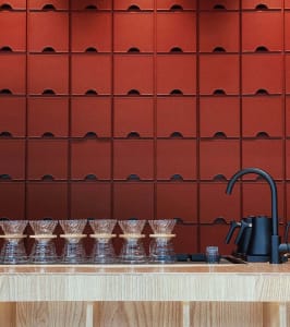 Warm and inviting kitchen space with wooden countertops, cabinets, and a sink, featuring several cups on the counter
