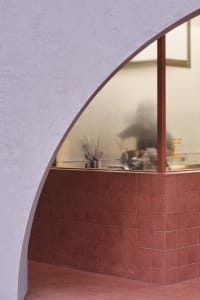 A clean and organized restaurant counter with bowls and knives, set in a foreign establishment