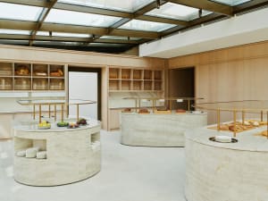 A warm and inviting kitchen with displayed food, bottles, and a comfortable atmosphere for cooking and dining