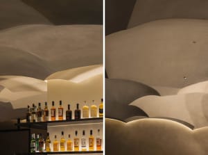A well-stocked bar with wooden accents, bottles, and a cozy atmosphere, perfect for socializing and enjoying drinks