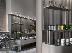 A well-organized kitchen with a countertop and shelf, featuring cups and bottles, with an emphasis on functionality and aesthetics