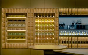 A well-lit retail store with multiple rows of shelves displaying bottles and cups, creating a clean and organized shopping environment