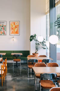 Cozy restaurant interior with wooden tables and chairs, warm ambiance, and inviting atmosphere