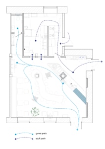 2D floor plan of a modern hotel with various rooms connected by hallways and staircases, featuring a mix of open and enclosed areas
