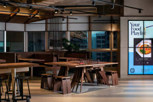 Warm and inviting restaurant interior with wooden tables and chairs, surrounded by pleasant lighting