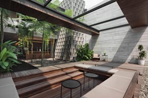 A modern indoor living area with a wooden deck, multiple seating options, potted plants, and a comfortable ambiance
