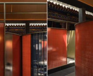 Dining area with tables and chairs in an Asian restaurant featuring red and gold walls, orange curtains, and decorative vases