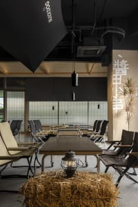 Cozy modern dining space with tables and chairs, dimly lit with clean lines and minimal decoration