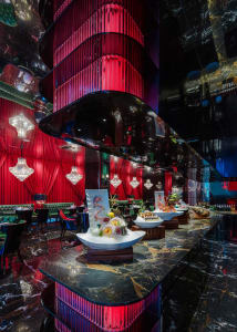 Sophisticated dining space with a large wooden table, chairs, and multiple bowls of food, set in a warm and inviting atmosphere