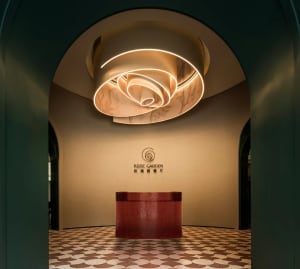 A modern hotel lobby with a red countertop, likely made of marble or granite, in an elegant and inviting atmosphere