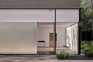 A modern kitchen with two sinks, a dining table, and chairs, surrounded by clean and well-organized space with a focus on functionality and modern design elements