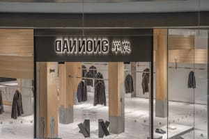 A well-lit modern store with clothing items on display, showcasing various sizes and colors in a well-organized layout