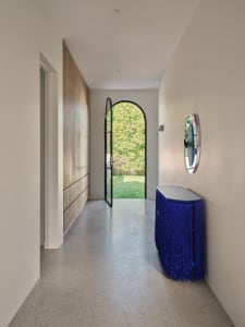 Open concept living area with a modern kitchen and dining room, featuring a sink, refrigerator, table, and chairs, with a focus on creating an inviting atmosphere