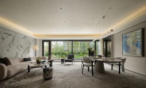 Open living space with a white table, chairs, couches, and a vase, giving a clean and contemporary feel