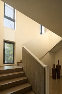A cozy staircase with wooden steps, two vases on either side, and a warm inviting atmosphere