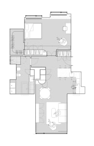 White floor plan of an apartment building with various rooms, furniture, and essential items, showcasing modern and functional design with open spaces and efficient use of areas