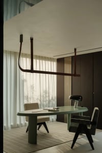 A calm and organized office space with a desk, chair, couch, and minimal decor