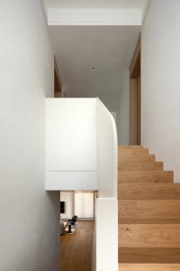 Two wooden staircases with a cozy and comfortable atmosphere, suggesting a living environment