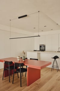 Warm and inviting dining space with a wooden table and black metal chairs
