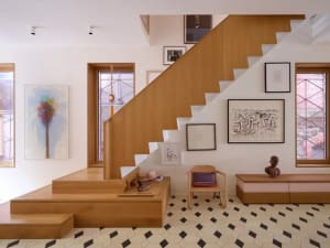 A cozy home interior featuring a wooden staircase with multiple pictures on the walls, adding a personal touch to the space