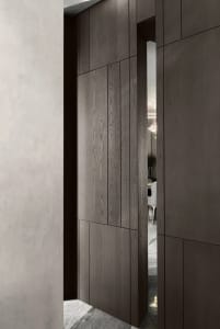 A warm and inviting home entrance with a wooden doorway leading to a dining area with a table and chairs