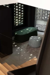 Cozy living area with two round ottomans, a rug, and two couches, a chair, and a window