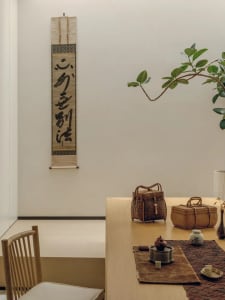 A warm and inviting dining area with a wooden table and chairs, set with various items and surrounded by a cozy atmosphere