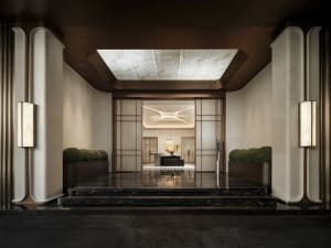 A modern lobby with a marble floor, decorated with various potted plants of different sizes, creating a visually appealing and inviting atmosphere