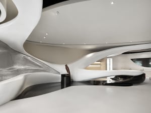 A modern, white, and curved building with a large, open interior and a clean and minimalist design
