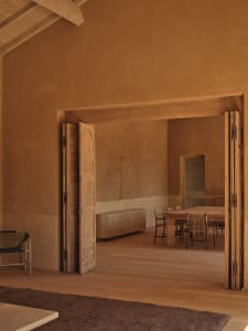 Dining area with a wooden floor, a dining table, and natural light from a doorway