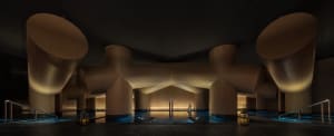 A modern building with a swimming pool surrounded by a wooden structure, creating a relaxing and luxurious atmosphere