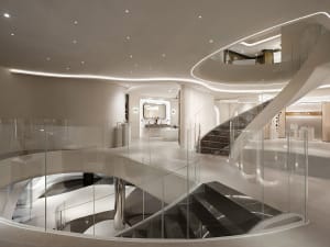 Large modern building with a glass spiral staircase, high ceiling, and open space, featuring clean lines and minimalistic design