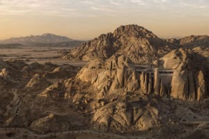 A dramatic rock formation in an outdoor environment with earth tones and natural lighting