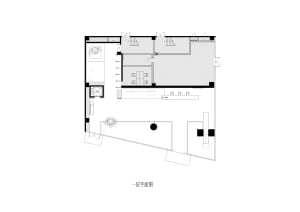 Black and white floor plan of a residential area with a living room, dining room, and kitchen, featuring clean lines and minimalistic design elements