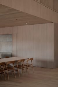 Dining room with wooden walls and table, wooden chairs, and a warm inviting atmosphere