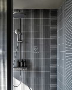 Bathroom with a shower and black and white tiles, minimalistic and functional design with clean lines and simple layout