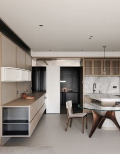 Cozy kitchen dining area with a glass table, wood accents, and dim lighting