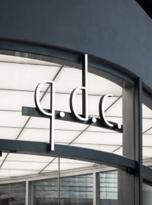 A modern building with a large glass window displaying a sign reading 'ddc' in a bright and inviting atmosphere