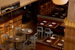 Cozy restaurant interior with wooden furniture, white plates, and dim lighting
