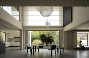 Large open living room with a dining area, natural light, and modern furniture