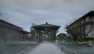 A photograph of a building with a black roof surrounded by trees, featuring a wooden bridge over a pool of water leading to a pavilion