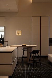 Warm and inviting kitchen with a wooden table, metal appliances, and natural light
