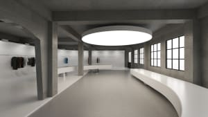 A large, empty lobby with a concrete floor, dimly lit, creating a moody atmosphere